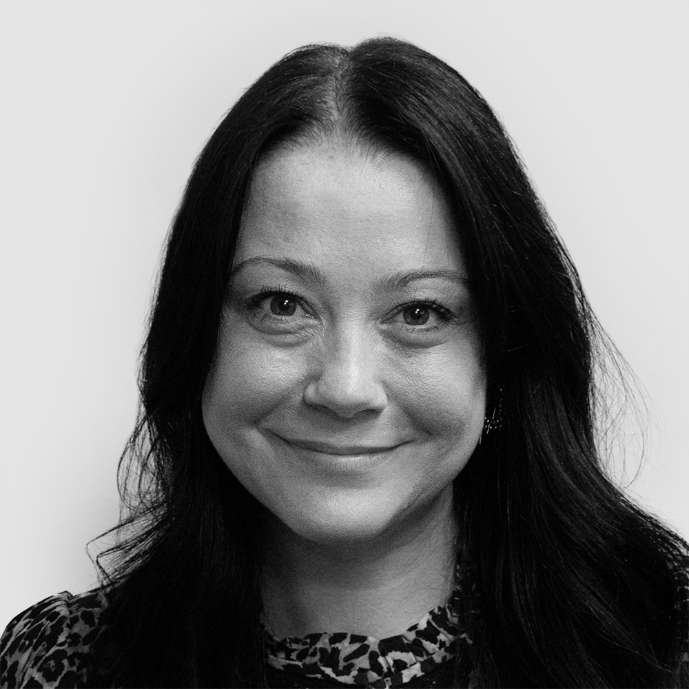 A black and white headshot of Emma Hollingworth, Chief Distribution Officer